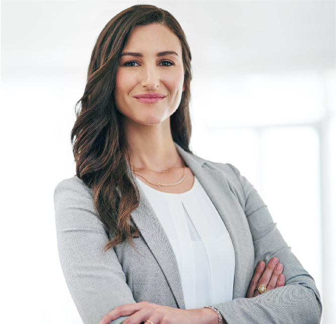 Confident young business woman with arms crossed.